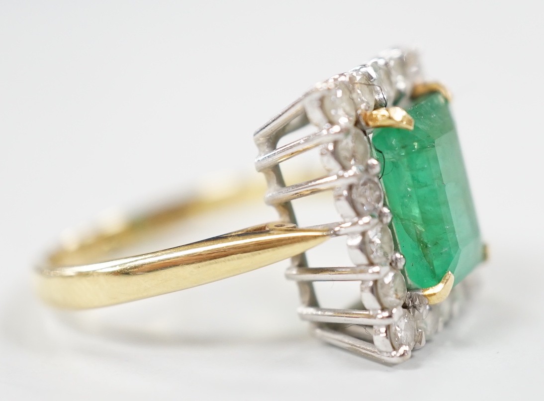 A modern 18ct gold, emerald and diamond set rectangular cluster ring, size Q, gross weight 6.4 grams.